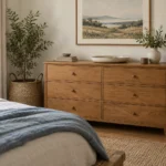 AI-created bedroom styling inspiration with a warm-wood dresser, oatmeal bedding, soft-blue throw and woven textures; not a reviewed product